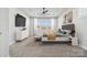 Bright bedroom featuring a tray ceiling, neutral colors, and large windows with natural light at 2006 Mantle Ridge Dr, Indian Trail, NC 28079