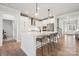Kitchen offers a seamless design with white cabinets, stainless steel appliances, and a large island at 2006 Mantle Ridge Dr, Indian Trail, NC 28079