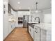 Modern kitchen with stainless steel appliances, island with sink and ample counter space, and wood floors at 2006 Mantle Ridge Dr, Indian Trail, NC 28079