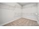 Empty walk-in closet with carpeted floors, built-in shelving, and ample storage space at 2006 Mantle Ridge Dr, Indian Trail, NC 28079