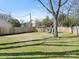 Large backyard with green grass, privacy fence, and play set for  at 2028 Scott Ave, Charlotte, NC 28203