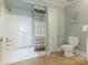 Clean bathroom with tiled floors and a classic vanity and shower-tub combo at 2028 Scott Ave, Charlotte, NC 28203