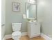 Charming half-bathroom with a classic white vanity and neutral decor at 2028 Scott Ave, Charlotte, NC 28203