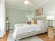 Bright bedroom with a ceiling fan, hardwood floors, and neutral decor at 2028 Scott Ave, Charlotte, NC 28203