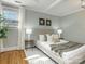 Comfortable bedroom with hardwood floors, neutral decor, and bright, natural light at 2028 Scott Ave, Charlotte, NC 28203