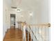 Bright hallway featuring hardwood floors, white walls, and decorative lighting fixtures at 2028 Scott Ave, Charlotte, NC 28203