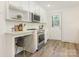 Bright eat-in kitchen with white cabinets, stainless steel appliances, and modern countertops at 2028 Scott Ave, Charlotte, NC 28203