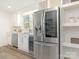 Renovated kitchen featuring stainless steel appliances, white cabinets, and bright, natural light at 2028 Scott Ave, Charlotte, NC 28203