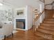 Inviting living room with hardwood floors, a fireplace, and staircase, creating an ideal gathering space at 2028 Scott Ave, Charlotte, NC 28203