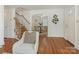 Open-concept living area with hardwood floors, a staircase, and a view of the dining room, great for entertaining at 2028 Scott Ave, Charlotte, NC 28203