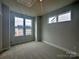 Bedroom with carpeted floor and multiple windows for ample natural light at 2035 Clarksdale Dr # 33, Charlotte, NC 28206