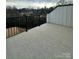 Spacious deck with black metal railing offering beautiful outdoor views of greenery and overcast skies at 2035 Clarksdale Dr # 33, Charlotte, NC 28206