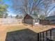 Backyard view shows a large yard with mature trees and an outbuilding with stone facade at 2112 Floral Ave, Charlotte, NC 28203