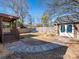 Large backyard with stone outbuilding, wooden deck, patio area and walkway at 2112 Floral Ave, Charlotte, NC 28203