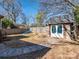 Spacious backyard with stone-accented outbuilding, pathway and privacy fence at 2112 Floral Ave, Charlotte, NC 28203