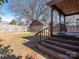 Spacious backyard featuring a deck, steps, a storage building, and mature trees at 2112 Floral Ave, Charlotte, NC 28203