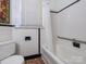 Classic bathroom features white tile, a tub with shower, and a window at 2112 Floral Ave, Charlotte, NC 28203