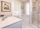 Bright bathroom features a shower, tub, window and a pristine white vanity at 2112 Floral Ave, Charlotte, NC 28203