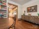 Dining room featuring a wood accent cabinet, wood floors and access to the kitchen at 2112 Floral Ave, Charlotte, NC 28203