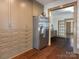 Modern kitchen design featuring built-in storage and stainless steel refrigerator at 2112 Floral Ave, Charlotte, NC 28203