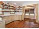 Bright and airy kitchen featuring open shelving, granite countertops, and wood floors at 2112 Floral Ave, Charlotte, NC 28203