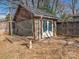 A stone storage building in the backyard with a small deck and stone pavers at 2112 Floral Ave, Charlotte, NC 28203