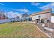 Grassy backyard with a patio, grill, and privacy fence creating a peaceful retreat at 2324 Lanza Dr, Charlotte, NC 28215