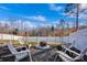 Backyard with a fire pit area surrounded by Adirondack chairs and string lights at 2324 Lanza Dr, Charlotte, NC 28215