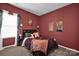 The cozy bedroom has a plush bed with decorative pillows, and is decorated with unique wall art at 2324 Lanza Dr, Charlotte, NC 28215