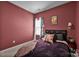 The cozy bedroom has a plush bed with decorative pillows, and is decorated with unique wall art at 2324 Lanza Dr, Charlotte, NC 28215
