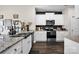 Modern kitchen featuring white cabinets, stainless steel appliances, and stylish subway tile backsplash at 2324 Lanza Dr, Charlotte, NC 28215