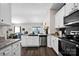 Bright kitchen featuring granite countertops, stainless steel appliances, and open layout to living area at 2324 Lanza Dr, Charlotte, NC 28215