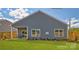 Beautiful home backyard featuring a covered porch and lush green lawn at 233 Giant Oak Ave, Statesville, NC 28677