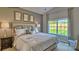 Bright bedroom featuring a plush bed, neutral walls and a view of the outdoors at 233 Giant Oak Ave, Statesville, NC 28677