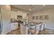 Well-lit kitchen featuring white cabinets, stainless steel appliances, and a center island with seating at 233 Giant Oak Ave, Statesville, NC 28677