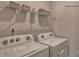 Well-equipped laundry room with a washer and dryer and wire rack for organizing towels at 233 Giant Oak Ave, Statesville, NC 28677