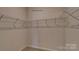 Walk-in closet features metal racking system for organized storage at 233 Giant Oak Ave, Statesville, NC 28677