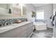 Bathroom with double sink vanity, granite countertops, blue backsplash, and soaking tub at 2864 Sweeping Pine Ln, Denver, NC 28037