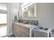 Bathroom featuring double vanity, granite countertops, blue glass tile backsplash and grey cabinets at 2864 Sweeping Pine Ln, Denver, NC 28037