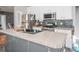 Modern kitchen features stainless steel appliances and a central island with a sink at 2864 Sweeping Pine Ln, Denver, NC 28037