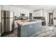 Modern kitchen features stainless steel appliances and a central island with a sink at 2864 Sweeping Pine Ln, Denver, NC 28037