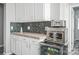 Kitchenette with white cabinetry, subway tile backsplash, countertops, and stainless steel appliances at 2864 Sweeping Pine Ln, Denver, NC 28037