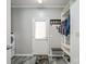 Mudroom with white cabinetry, door to exterior, bench, coat rack, and gray flooring at 2864 Sweeping Pine Ln, Denver, NC 28037