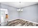 Dining area with chandelier, modern flooring, and an open view to the kitchen at 3008 Semmes Ln, Indian Trail, NC 28079