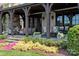 Covered back porch featuring stone columns, a fireplace, outdoor seating and views of professionally landscaped grounds at 314 Royal Crescent Ln, Waxhaw, NC 28173