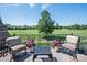 Outdoor balcony with golf course views, seating, flower arrangements, and patterned rug providing an idyllic outdoor experience at 314 Royal Crescent Ln, Waxhaw, NC 28173