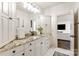 Bathroom with granite counters, white cabinets, and marble floors for a clean design at 314 Royal Crescent Ln, Waxhaw, NC 28173