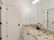 Bathroom with white cabinets and granite countertops, bright lighting, and white doors at 314 Royal Crescent Ln, Waxhaw, NC 28173
