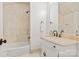 Bathroom with tiled shower and vanity with tan marble countertop and bronze hardware at 314 Royal Crescent Ln, Waxhaw, NC 28173