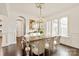 Elegant dining room with wainscoting, chandelier, and hardwood floors at 314 Royal Crescent Ln, Waxhaw, NC 28173